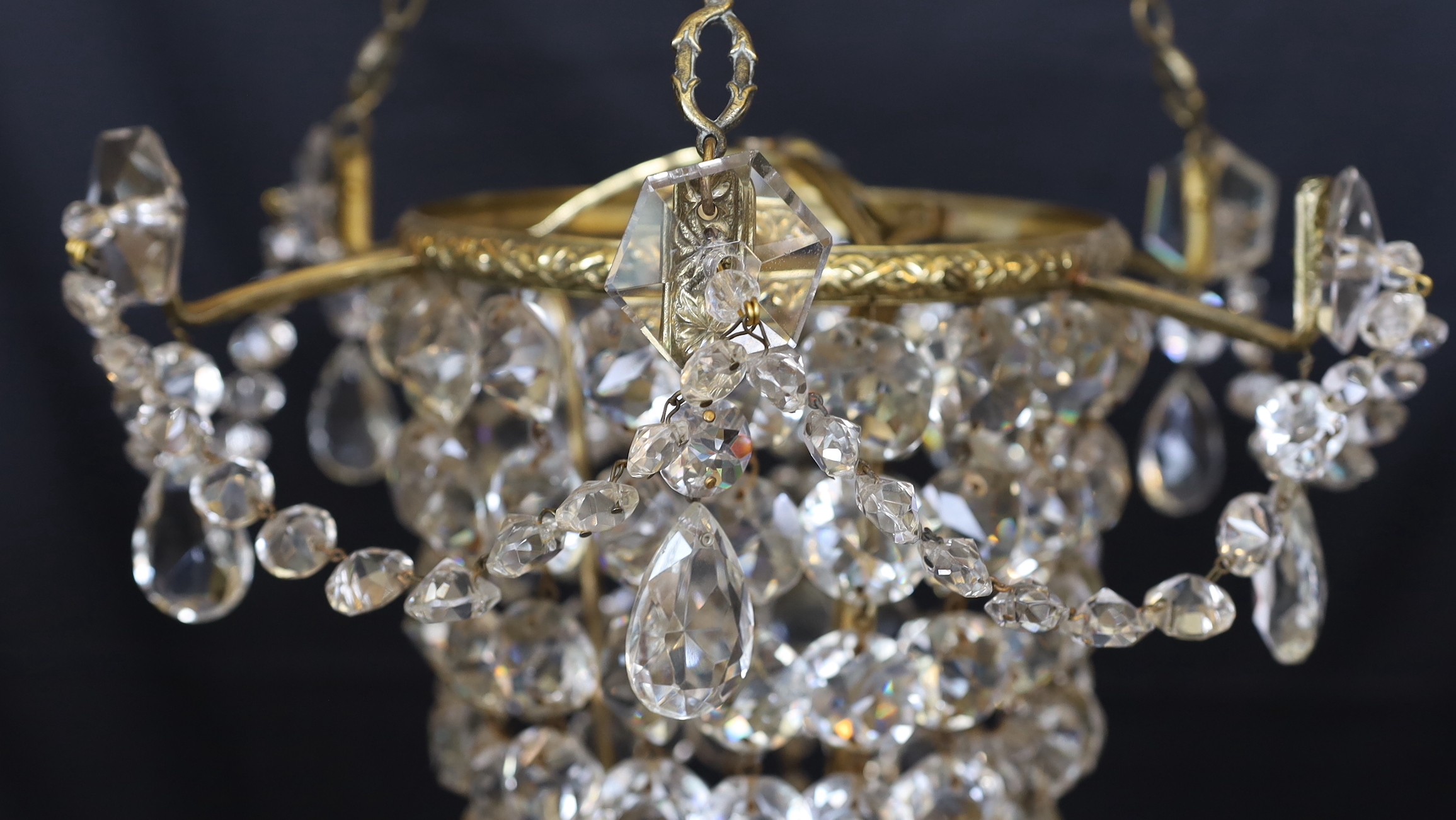 A 1930s lead crystal and brass bag shaped light fitting, height 53cm. width 36cm